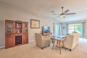 a living room with a ceiling fan and a table and chairs at Charming Home with Lanai, 8 Mi to Town Square! in The Villages
