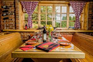 a table with glasses and a bottle of wine at Hotel Enigma in Žabljak