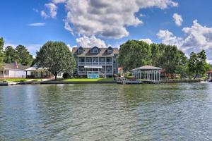 a house on the water in front of a lake at Picturesque Abode with Dock on Jackson Lake! in Jackson