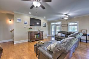 a living room with a couch and a flat screen tv at Picturesque Abode with Dock on Jackson Lake! in Jackson
