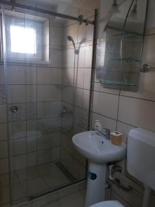 a bathroom with a toilet and a sink and a shower at Apartament Nicoleta in Jurilovca