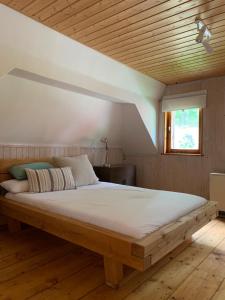 a large bed in a room with a wooden ceiling at Familien Ferienhaus in Bad Elster Vogtland - Natur pur und Wellness in Bad Elster +44 photos