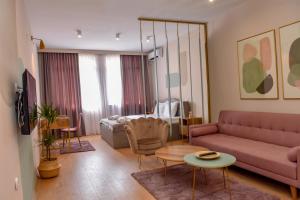 a living room with a couch and a table at Good Times Luxury Apartments Bitola in Bitola