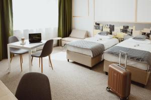 Łóżko lub łóżka w pokoju w obiekcie Arche Hotel Poloneza