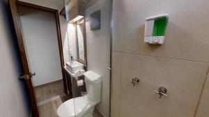 a bathroom with a toilet and a sink at Tokio Suites in Mexico City
