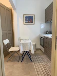 a small kitchen with a table and a chair at Swash & Ripple Studio by the sea in Mytikas +13 photos
