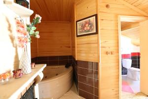 a bathroom with a tub in the corner of a room at Assortie La Villa Hotel in Ağva