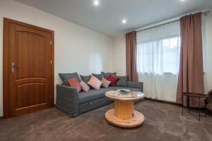 a living room with a couch and a table at Dworek Pod Jodłami in Zakopane