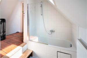 a bathroom with a shower and a bath tub at Antwerp Old Town Centrum Apartment in Antwerp