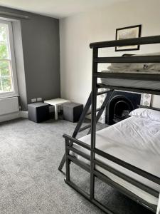 a bedroom with a bunk bed and a fireplace at YHA Cheddar in Cheddar