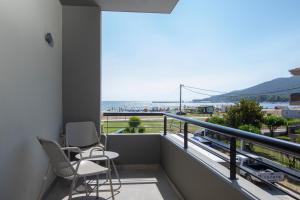 a balcony with two chairs and a view of the beach at Allonda Seafront Experience in Stavros