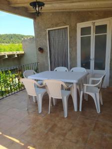 a white table and chairs on a patio at Cal Ferrer de Tarres in Tarrés