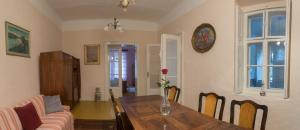 a dining room with a table and a couch at Kuća za odmor Weinrauch in Ilok +7 photos