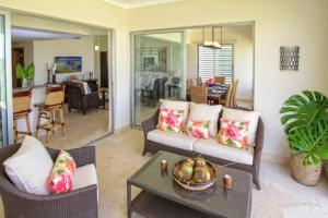 a living room with a couch and a table at Spacious 3 BDR fully-equipped condo with pool and golf view in Punta Cana