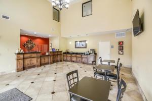 a restaurant with tables and chairs in a room at Americas Best Value Inn & Suites Tomball in Tomball