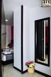 a room with a mirror and a basket of flowers at Apartamento cerca al parque del cafe in Montenegro +36 photos