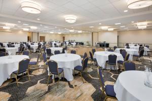 a large room with tables and chairs and white tables at Holiday Inn University Area Charlottesville, an IHG Hotel in Charlottesville