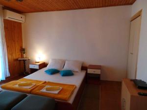 a bedroom with a bed and a blue couch at Apartment in Valbandon - Istrien 8608 in Valbandon