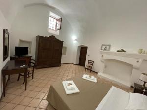 a living room with a bed and a fireplace at Masseria Artemisia in Torre San Giovanni Ugento