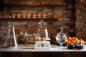 a counter with two glass domes and a bowl of fruit at Adis Oneirou in Mouresi