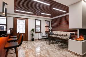 a room with chairs and a kitchen with a fireplace at Xenia Hotel Istanbul in Istanbul