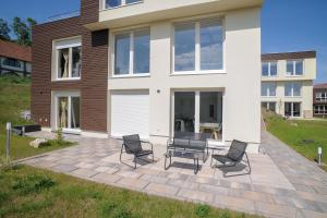 a group of chairs sitting on a patio in front of a house at Designapartments Die besondere ART - Sennhütte 7 in Wernigerode