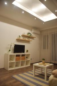 a living room with a tv and a table at Feel Danube apartment in Zemun