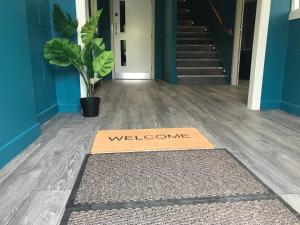 a welcome mat on the floor of a hallway at Rostrevor Mountain Lodge Hostel Accommodation in Rostrevor +159 photos