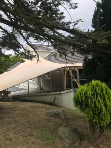 a house with a white tent in front of it at Rostrevor Mountain Lodge "Cosy & Friendly" in Rostrevor