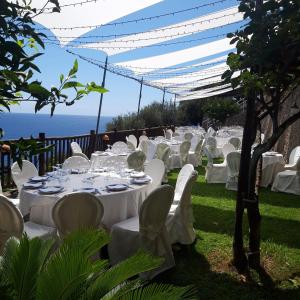 a table set up for a wedding with the ocean in the background at Hotel Costa Diva in Praiano