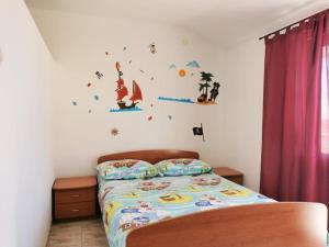 a bedroom with a bed with stickers on the wall at Apartments Jaki - 150 m from beach in Orebić