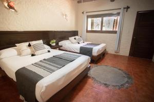 Postel nebo postele na pokoji v ubytování Hotel Macondo Holbox