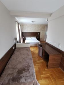 a bedroom with a bed and wooden floors at Villa Salvia in Mostar