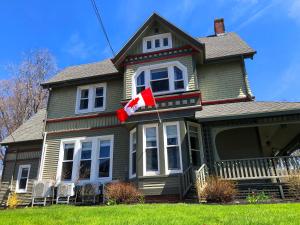 a house with a canadian flag on the front of it at No 1 Grafton Inn in Charlottetown