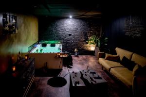 a living room with a pool table and a couch at LOVE Suites & SPA "Le Loft" avec Jacuzzi privatif in Médis