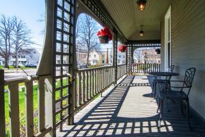 a porch with a table and chairs on a house at No 1 Grafton Inn in Charlottetown