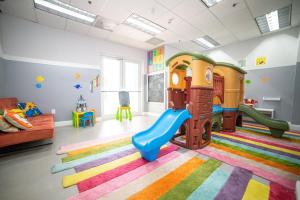 a childrens play room with a slide and a playground at High Rise Brickell Modern Studio in Miami