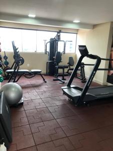a gym with treadmills and exercise equipment in a room at Manaíra Apart Hotel - Flat 201 in João Pessoa