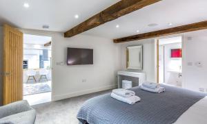a bedroom with a bed with two towels on it at The Shippon Cottage in Kendal