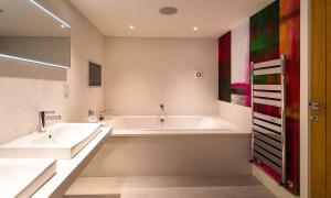 a bathroom with two sinks and a bath tub at The Shippon Cottage in Kendal +13 photos