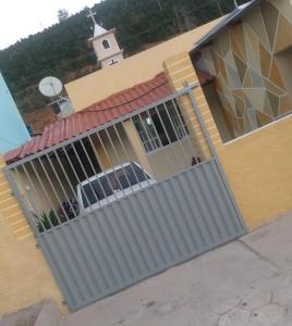 a building with a gate on the side of it at Hospedagem Roze - in São José de Pedra Menina