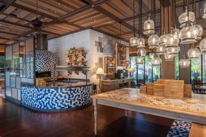 a room with a table and some glass lamps at Andaz Bali, By Hyatt in Sanur