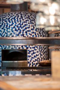 a pizza oven with blue and white tiles at Andaz Bali, By Hyatt in Sanur