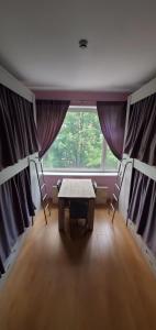 a room with a table and a large window at Hostel Ester House in Moscow