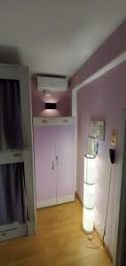 a room with a white door and a pink wall at Hostel Ester House in Moscow