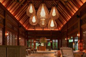 a pavilion with chandeliers and tables and chairs at Andaz Bali, By Hyatt in Sanur