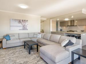 a living room with a couch and a table at Echidna Hollow in Cowes
