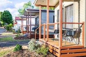 a deck on a house with a table and chairs at Kingaroy Holiday Park in Kingaroy