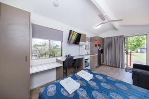 a hotel room with a bed and a television at Kingaroy Holiday Park in Kingaroy