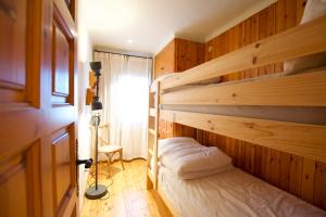 1 dormitorio con litera en una habitación de madera en Apartamento con encanto Alp, en Alp